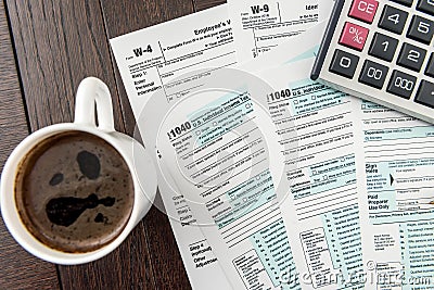 Office desk, time for break coffee cup with tax form Editorial Stock Photo