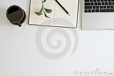 Office desk top view table with laptop, coffee, plant, notebook and pencil Stock Photo
