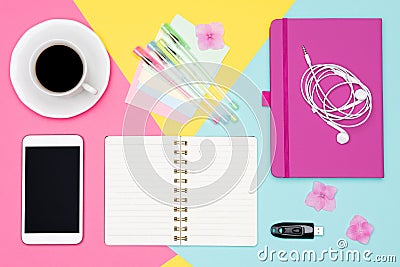 Office Desk Working Space Flat Lay. Top view photo of workspace with blank mock up smartphone, coffee cup and open notepad. Stock Photo