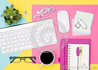 Office Desk Working Space Flat Lay. Top view photo of workspace with keyboard, notepad and coffee on pastel background. Stock Photo