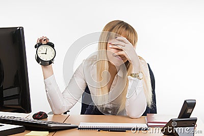 Office employee covered her face with his hand from the unwillingness to work Stock Photo