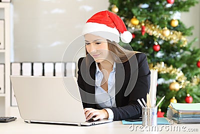 Office employee working in christmas with a laptop Stock Photo