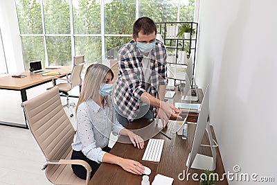 Office employees in respiratory masks Stock Photo