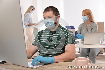 Office employees in respiratory masks Stock Photo