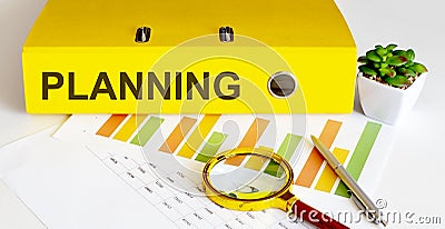 Office folder with text PLANNING with charts, magnifier and pen Stock Photo