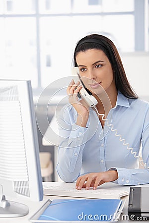 Office girl on landline call Stock Photo