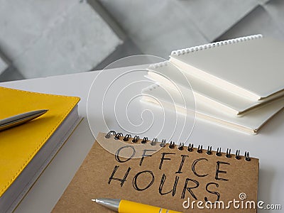 Office hours written by hands on the page. Stock Photo