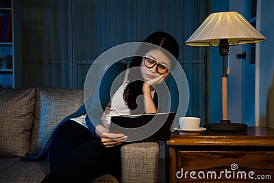 Office lady overwork with pad at home all night Stock Photo