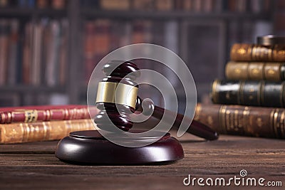 Wooden judge`s gavel and law books with treating of laws, legal issues, or cases Stock Photo