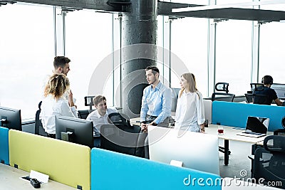 Office life. Group of young business people working and communicating together in creative office. Stock Photo