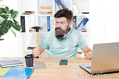 Office life makes him crazy. Businessman with beard and mustache gone mad with hammer in a hand. Angry aggressive Stock Photo