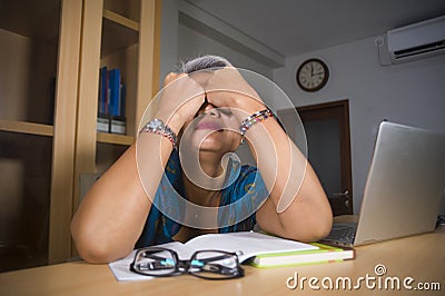Office lifestyle portrait of sad and depressed middle aged attractive Asian woman working on laptop computer desk stressed and Stock Photo