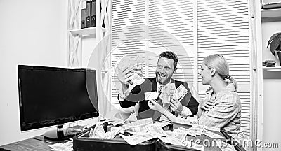 Office manager hold bank card. Man business owner sit office pile of money. Bank assistant offer plastic card. Create Stock Photo