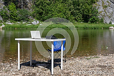 office on nature. outdoor workplace. computer, phone and table. Remote work and earning online Stock Photo