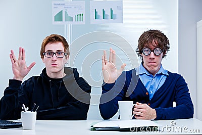 Office nerds gesturing prosperity salute Stock Photo