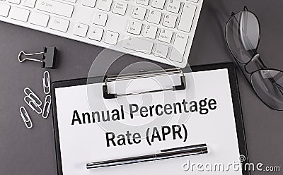 Office paper sheet with text Annual percentage rate with office tols and keyboard. Business Stock Photo