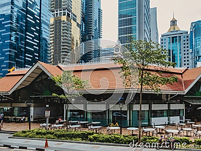 Office and residential towers skyscrapers towering over Lau Pa Sat hawker food markets in downtown Singapore Editorial Stock Photo