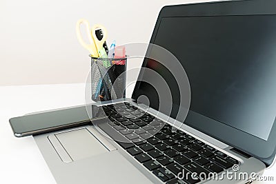 Office set up, Open laptop computer, smartphone and office suppl Stock Photo