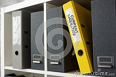 Office shelf with folder current liabilities. Stock Photo