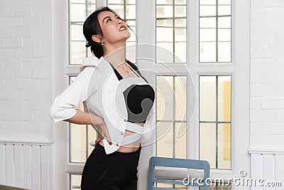 Office syndrome concept. Businesswoman twisting the body to relieve fatigue , suffering from pain after sedentary working in Stock Photo