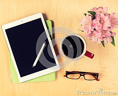 Office table with digital tablet, reading glasses and cup of coffee. View from above Stock Photo