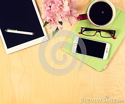 Office table with digital tablet, smartphone, reading glasses and cup of coffee. View from above Stock Photo