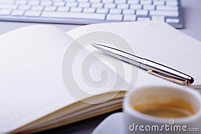 Office table with notebook, computer keyboard,, cup of coffee, tablet pc. copy space. Stock Photo