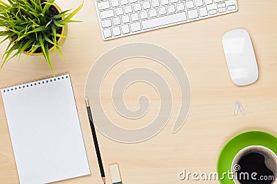 Office table with notepad, computer, flower and coffee cup Stock Photo