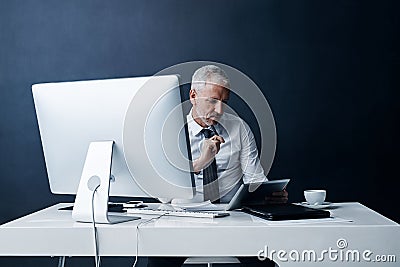 Office, thinking and business man on tablet online for social media, internet and browse website at desk. Networking Stock Photo