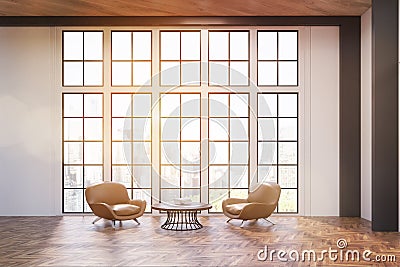 Office waiting room with two comfortable dark leather armchairs near a round coffee table. Stock Photo