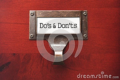 Office Wooden File Cabinet with Dos and Donts Labe Stock Photo