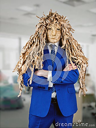 Office worker in a blue business suit put on a mask of a goblin jester Stock Photo