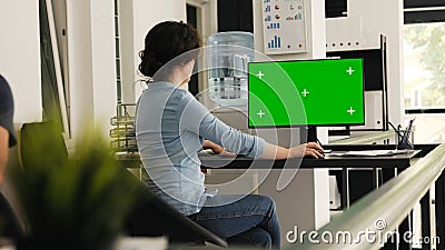 Office worker checks greenscreen Stock Photo