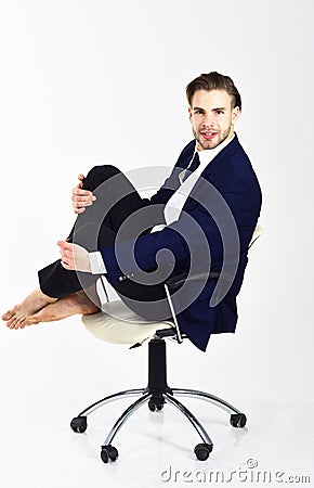 Office worker with cheerful face rolling in chair. Stock Photo