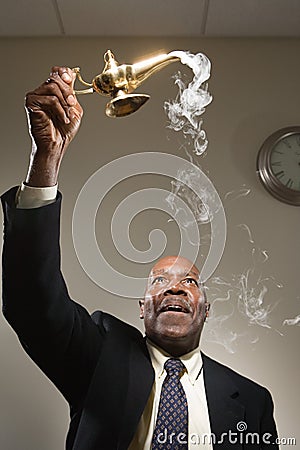 Office worker holding genie lamp Stock Photo