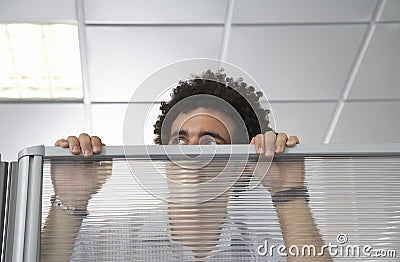 Office Worker Peering Over Cubicle Wall Stock Photo