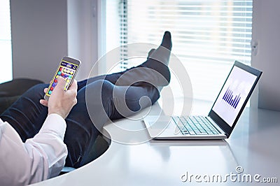 Office worker playing mobile game Stock Photo