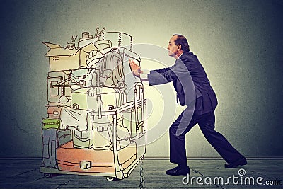 Office worker pushing heavy airport cart with travel backpacks and briefcases Stock Photo