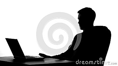 Office worker shadow sitting in front of laptop, thinking on business proposal Stock Photo