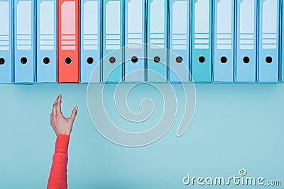 Office worker taking a folder in the archive Stock Photo