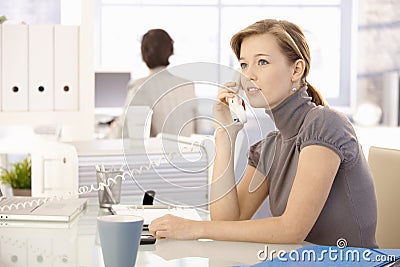 Office worker talking on phone Stock Photo