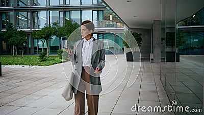 Office worker walking downtown street. Pensive executive stop to reply message Stock Photo
