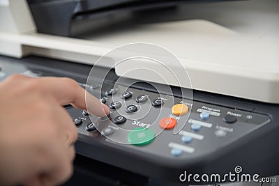 Office worker works with a multi-function device and sets the number of copies to print Stock Photo