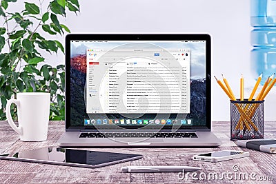 Office workplace with Apple Macbook with Google Gmail web page Editorial Stock Photo