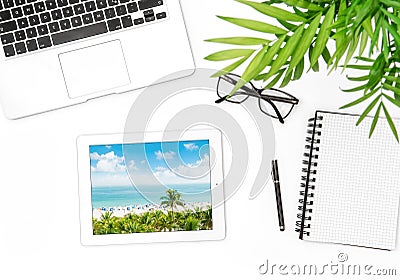 Office workplace flat lay Laptop tablet vacation photo green plant Stock Photo