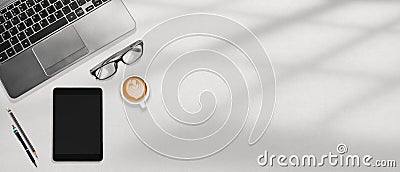 Office workspace flatlay laptop, tablet, eye glasses and coffee on the white desktop Stock Photo