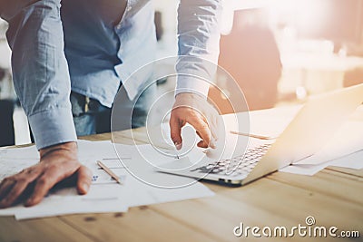 Office world. Businessman working at the wood table with new business project in modern coworking place. Man touching Stock Photo