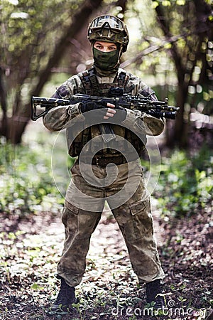 Officer with gun patrols forest Stock Photo