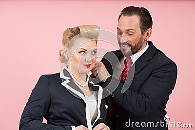 Officers couple flirting each other. man takes on white perls on girls neck. Guy looks into female breast Stock Photo