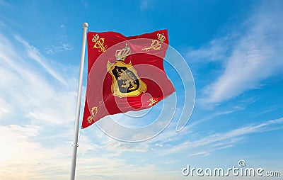 official flag of Royal Standard of Queen Paola , Belgium at cloudy sky background on sunset, panoramic view. Belgian travel and Cartoon Illustration